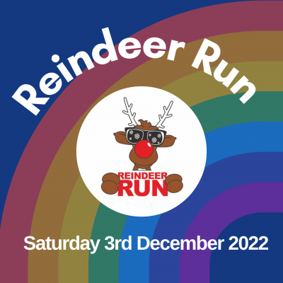 Dark blue square with a rainbow in the background behind white letters spelling Reindeer Run. Underneath a circle with a reindeer is the date Saturday 3rd December 2022
