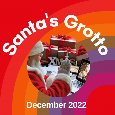 A red square with a rainbow in the background behind white letters spelling Santa's Grotto. Underneath a circle with a photo of Santa at a laptop is the text 'December 2022'