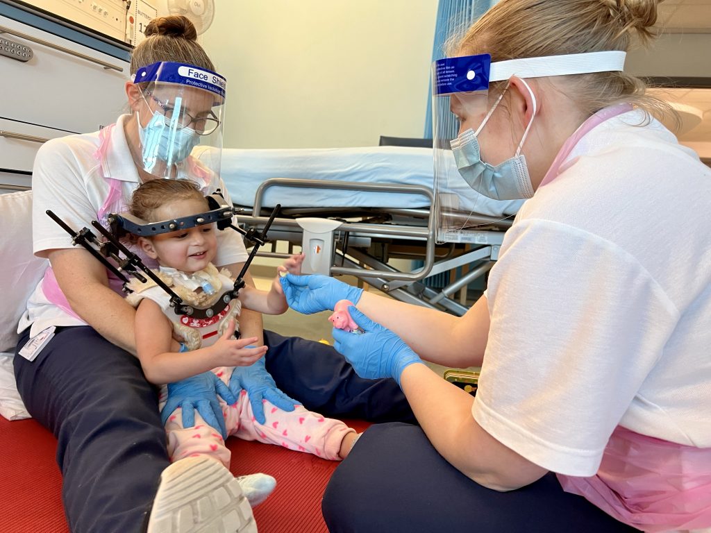 Alice with physiotherapists from the Noahs Ark Childrens Hospital for Wales 