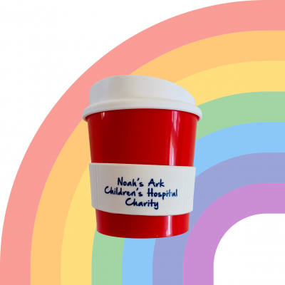 ID: A white background with a faded rainbow and in the forefront, a small red reusable coffee cup with a white lid and white heat band that reads 'Noah's Ark Children's Hospital Charity'